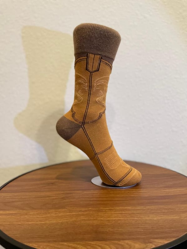 A camel and brown cowboy boot sock in profile, with a ribbed brown cuff.