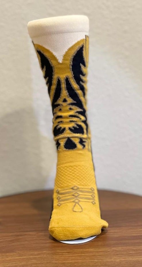 A cowboy boot sock displayed upright, showing the knitted shaft pattern in profile.