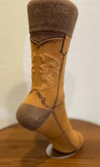 The back of the camel boot sock, showing the darker brown heel and the seam up the rear of the shaft.