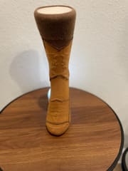 The camel boot sock standing upright, seen front on.