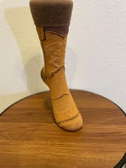 Three-quarter view of the camel boot sock showing the pale stitch detail on the shaft.