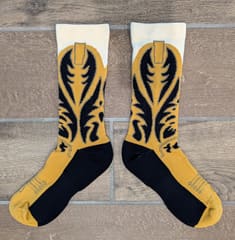 The pair laid flat side by side, showing the full knitted boot pattern.