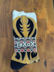 The pair folded with a printed western band wrapped around them.